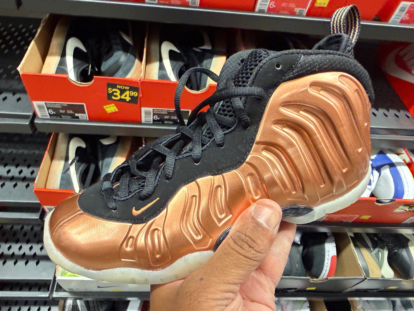 Metallic Copper Little Posites Hit Outlet for $79.99 at Nike Clearance Store — Marketplace Plaza